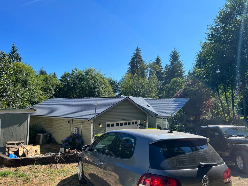 Deep Charcoal Interlock Cedar Shingle aluminum roof on a two-storey home with a metal roof in a forested setting, Longview, Washington