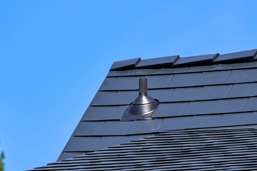 Black Interlock Slate aluminum roof on a black two-storey home with a metal roof in a suburban, Enumclaw, Washington