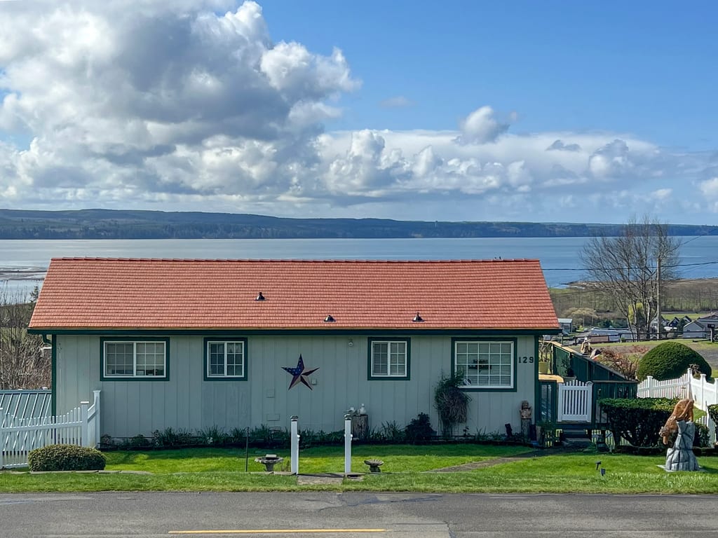 Copper Penny Interlock Cedar Shingle aluminum roof on a cottage-style home with a red metal roof on the waterfront, Hoquiam, Washington