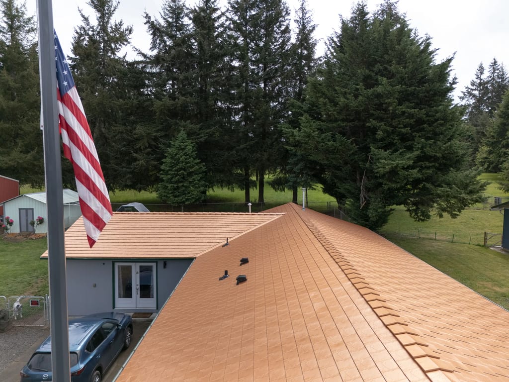 Copper Penny Interlock Slate aluminum roof on a copper roof on a two-storey home in a forested rural, Castle Rock, Washington