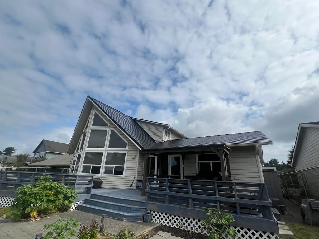 Black Interlock Slate aluminum roof on a black A-Frame home with a porch near the ocean, Ocean Shores, Washington