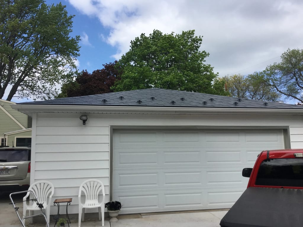 Charcoal Grey Interlock Slate aluminum roof on a white ranch home with a grey roof in a wooded suburban, Madison, Wisconsin