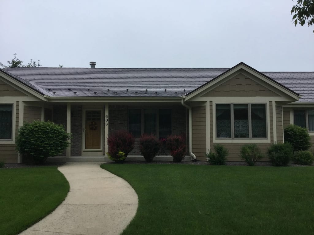 Colonial Brown Interlock Slate aluminum roof on a brown one-storey Colonial home in a rural setting, Port Washington, Wisconsin