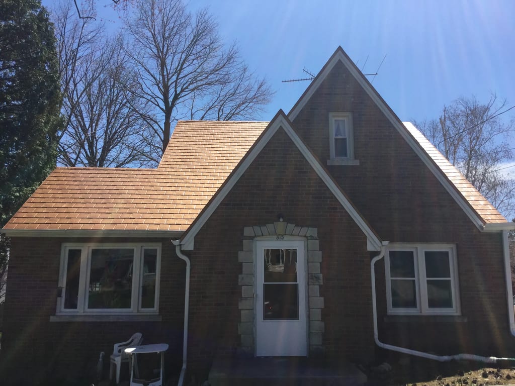 Aged Copper Interlock Slate aluminum roof on a brown one-storey home with dormers in a rural setting, Watertown, Wisconsin