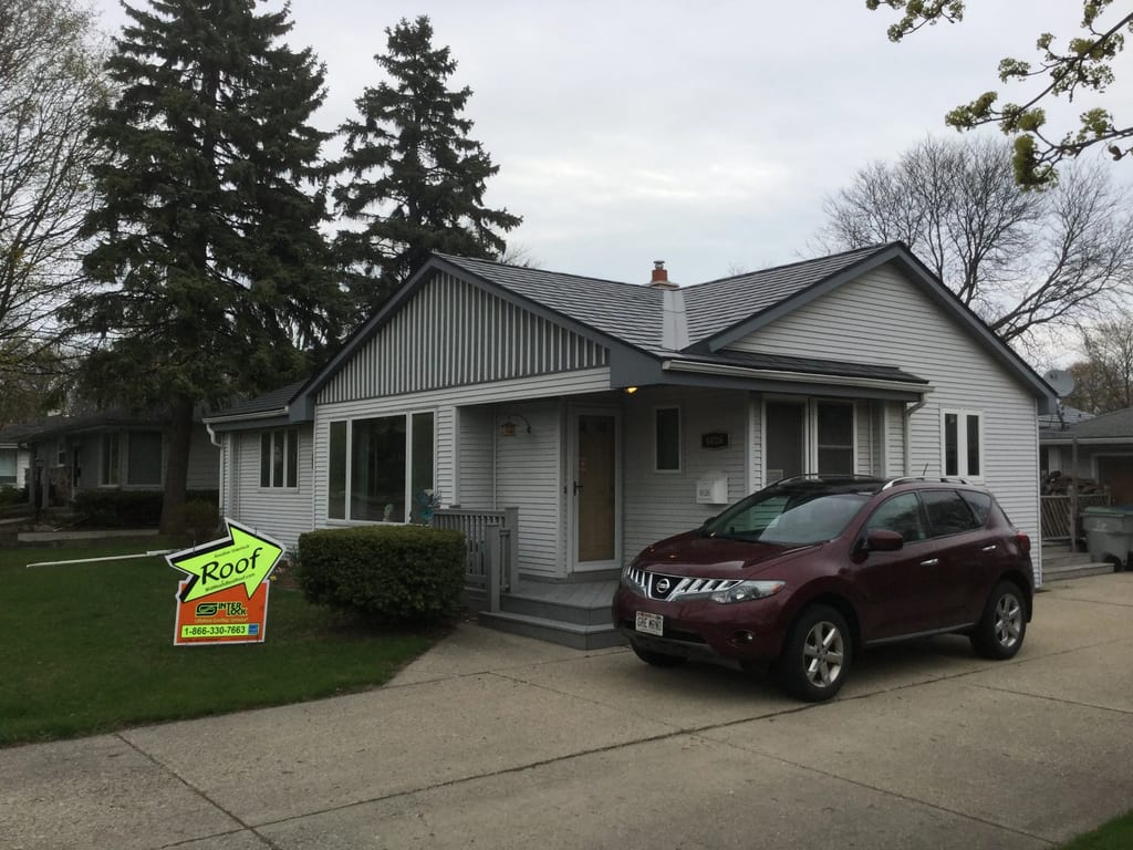 Deep Charcoal Interlock Slate aluminum roof on a white single-family home with a metal roof in a rural, Milwaukee, Wisconsin