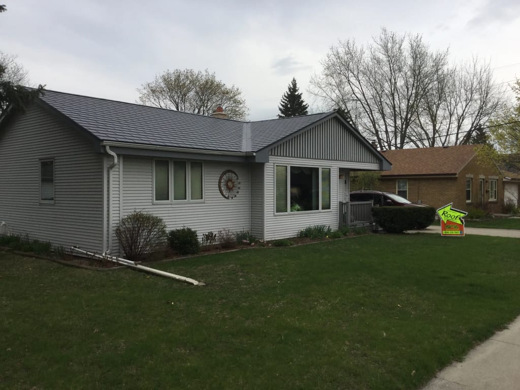 Deep Charcoal Interlock Slate aluminum roof on a Deep Charcoal Interlock Slate metal roof on a white ranch, Milwaukee, Wisconsin