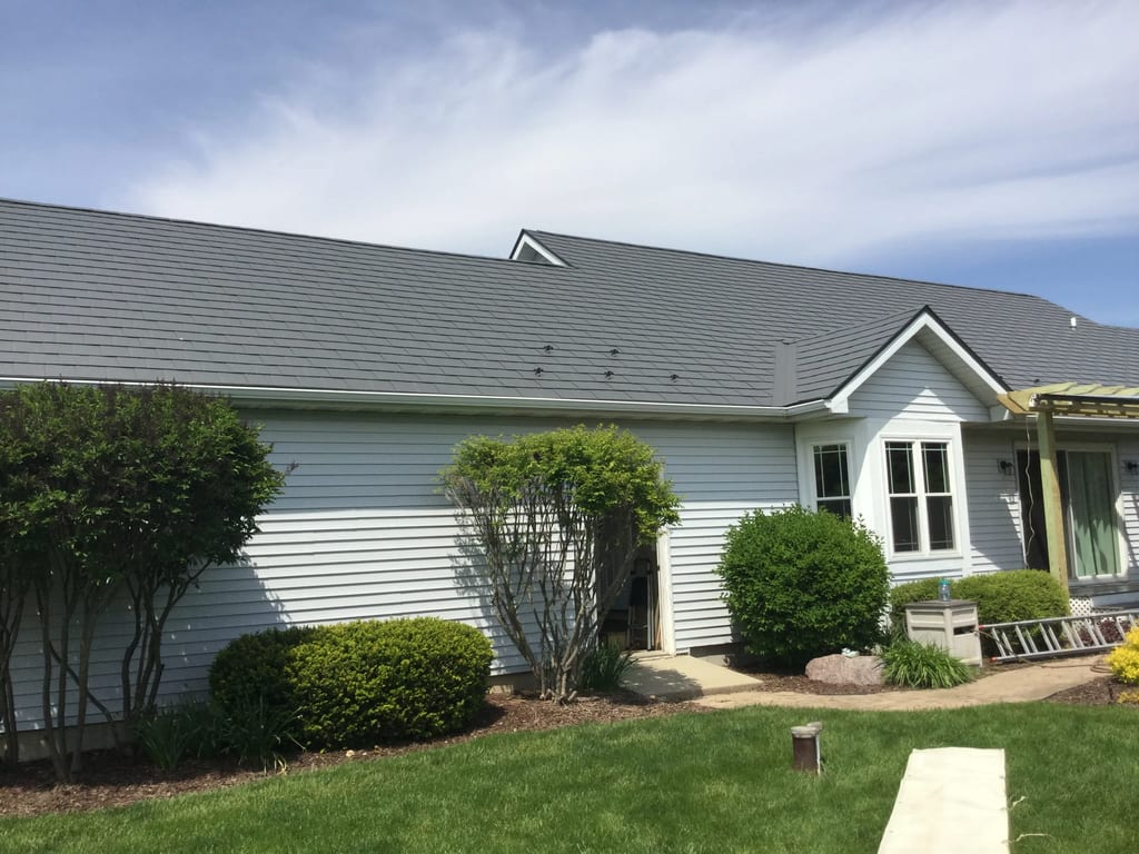 Tudor Brown Interlock Slate aluminum roof on a white two-storey Tudor home with dormers in a rural, Burlington, Wisconsin