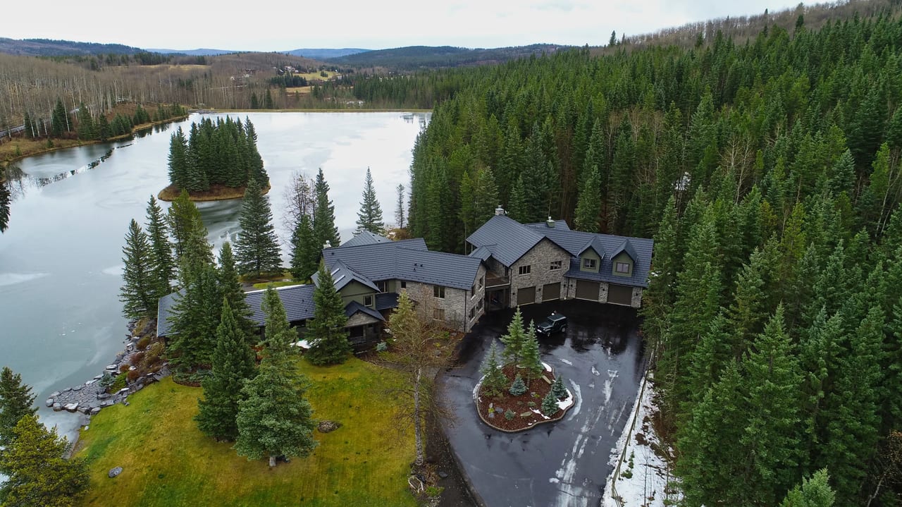 Black Interlock Shake aluminum roof on a two-storey chalet in a forested mountain setting, Bragg Creek, Alberta