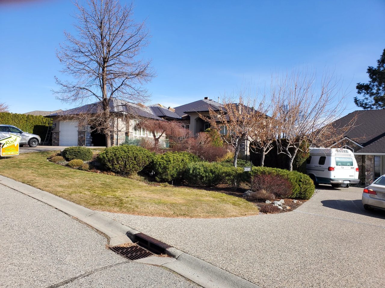 Tudor Brown Interlock Cedar Shingle aluminum roof on a Tudor brown single-family home in a suburban setting, West Kelowna, British Columbia