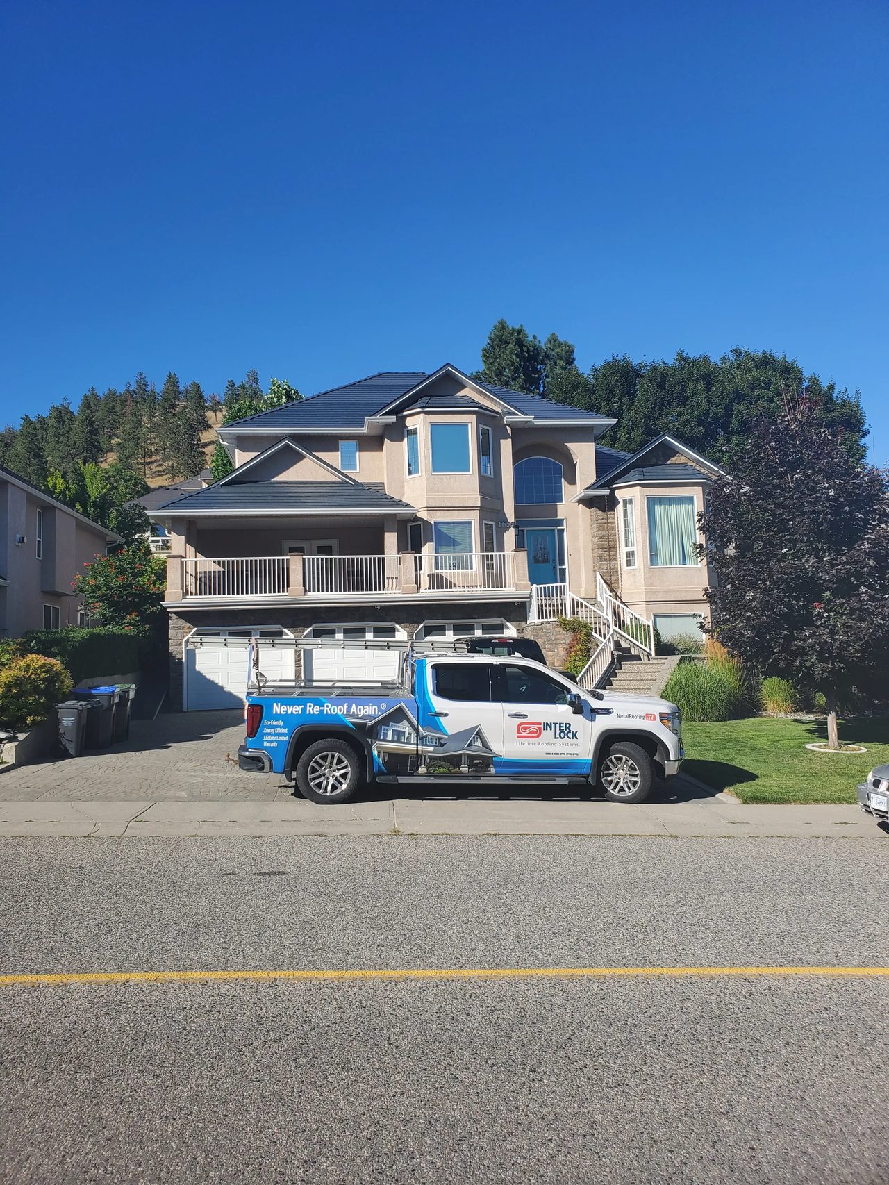 Deep Charcoal Interlock Slate aluminum roof on a modern single-family home with a metal roof in a forested, Kelowna, British Columbia
