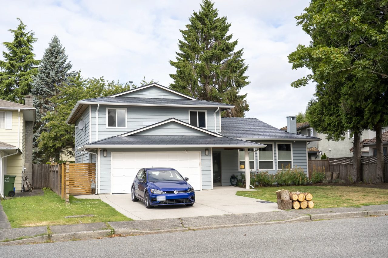Deep Charcoal Interlock Slate aluminum roof on a two-storey home with a metal roof in a suburban forest, Richmond, British Columbia