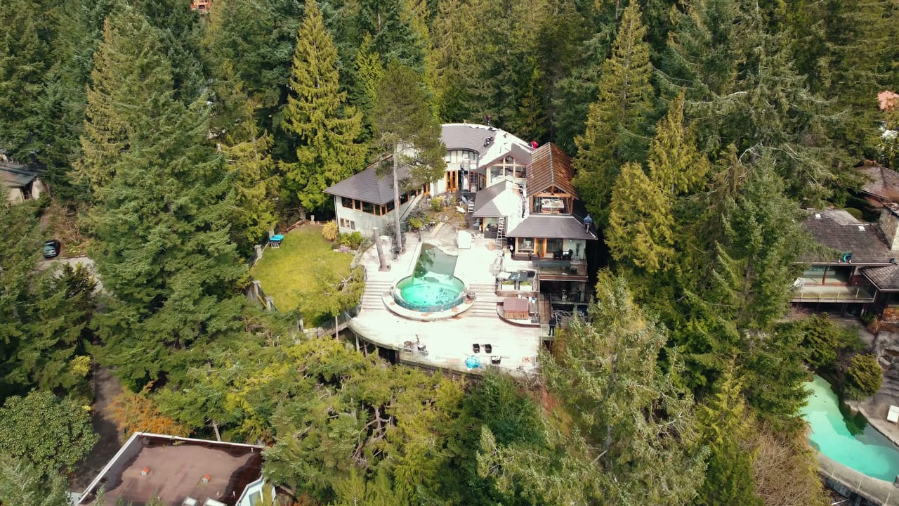 Interlock aluminum Tudor Brown slate metal roof on a home in West Vancouver, BC — the completed installation featured in the homeowner's video testimonial.