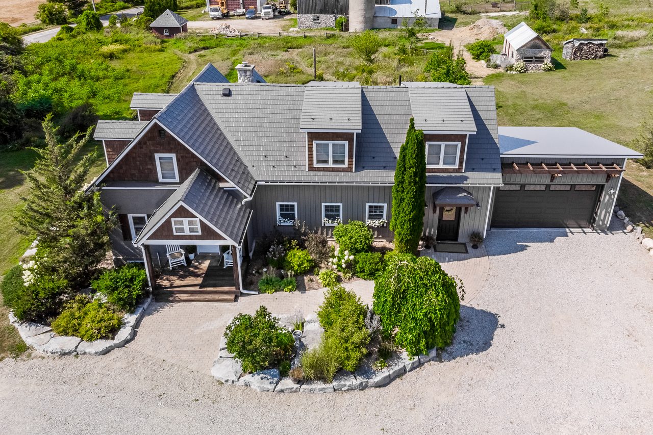Aerial front view of a Craftsman home in Midland, ON with Interlock cedar shingle aluminum roofing in Weathered finish, featuring multiple dormers, valleys, and attached garage.