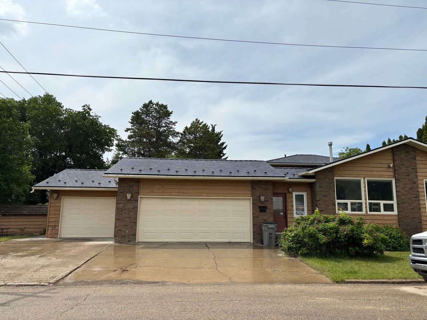 Black Interlock Slate aluminum roof on a brown ranch home with a metal roof in a rural suburban, Grande Prairie, Alberta
