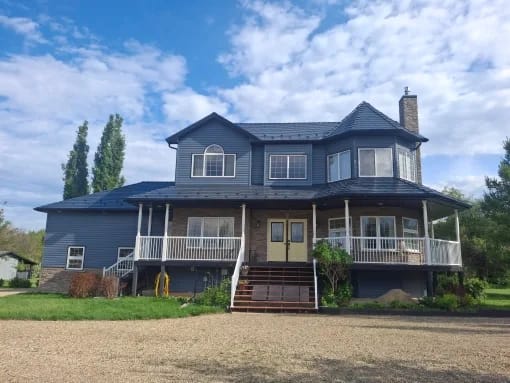 Deep Charcoal Interlock Slate aluminum roof on a two-storey home with a brown and black metal roof among, County of Grande Prairie, Alberta