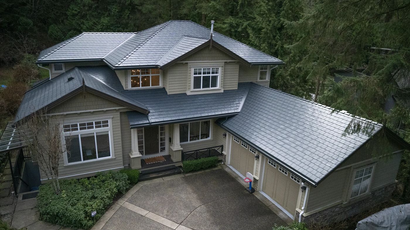 Deep Charcoal Interlock Slate aluminum roof on a modern home with a grey roof in a forested mountain, North Vancouver, British Columbia