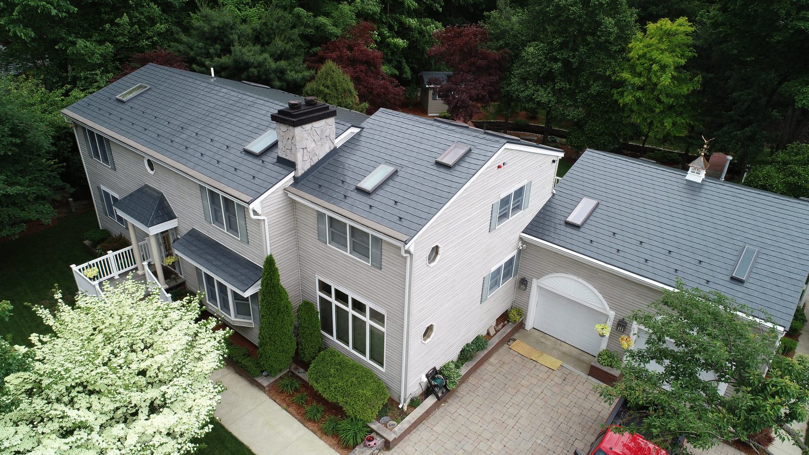 Deep Charcoal Interlock aluminum slate roof on a Colonial home in Bedford, MA — Aerial front view