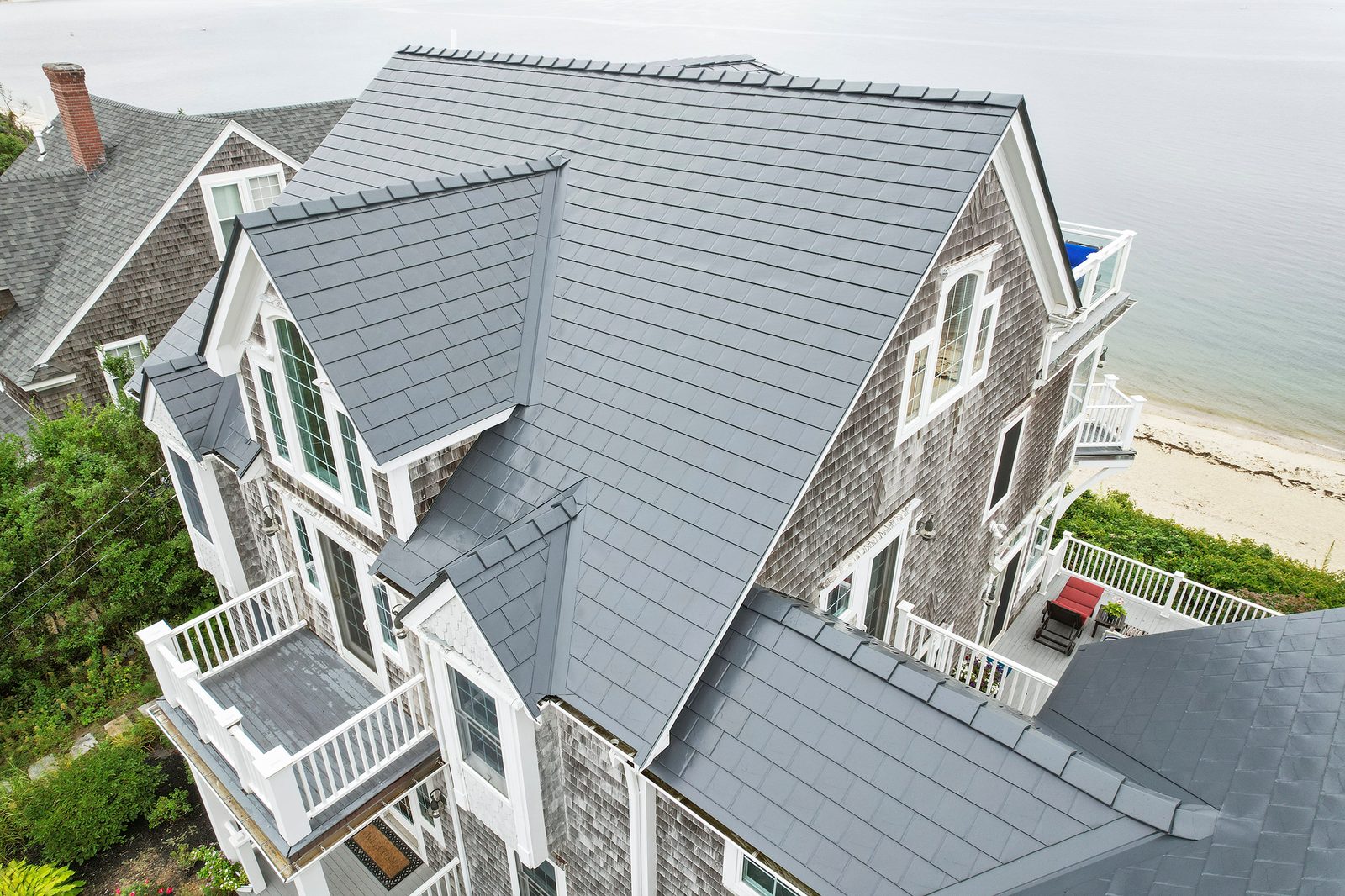 Deep Charcoal Interlock aluminum slate roof on a Victorian home in Sagamore Beach, MA — Aerial side view