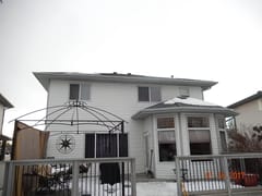 Deep Charcoal Interlock Slate aluminum roof on a white two-storey home with a metal roof in rural Alberta, Fort Saskatchewan, Alberta