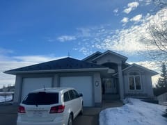 Black Interlock Slate aluminum roof on a white single-storey modern home with a dormer in the, Red Deer, Alberta