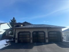 Black Interlock Slate aluminum roof on a beige ranch style home with snow on the ground, Red Deer, Alberta