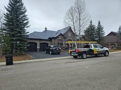 Deep Charcoal Interlock Slate aluminum roof on a two-storey home with a metal roof in a residential area, Calgary, Alberta