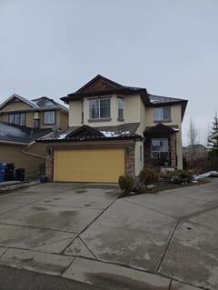 Colonial Brown Interlock Slate aluminum roof on a Colonial brown two-storey home with a brown roof among, Calgary, Alberta