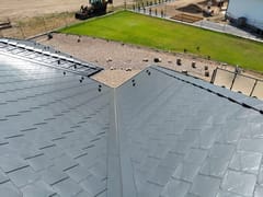 Deep Charcoal Interlock Slate aluminum roof on a Dunmore home with a metal roof in a rural setting, Dunmore, Alberta