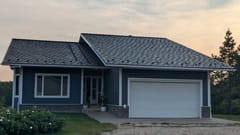 Colonial Brown Interlock Shake aluminum roof on a colonial-style home with a Colonial Brown metal roof in a, Crooked Creek, Alberta