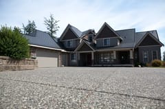 Black Interlock Slate aluminum roof on a dark grey home with two storeys and a gable roof in a, Surrey, British Columbia