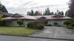 Tile Red Interlock Slate aluminum roof on a ranch home in a suburban setting with lush greenery, Delta, British Columbia