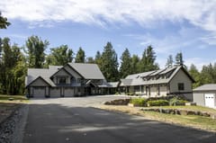 Musket Grey Interlock Slate aluminum roof on a grey modern home with dormers in a forested rural setting, Abbotsford, British Columbia
