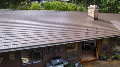 Colonial Brown Interlock Cedar Shingle aluminum roof on a brown one-storey home with a colonial style and a metal, Salt Spring Island, British Columbia