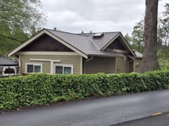 Colonial Brown Interlock Slate aluminum roof on a brown colonial home among trees, Shawnigan Lake, British Columbia