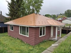 Copper Penny Interlock Slate aluminum roof on a brown house with a copper penny metal roof in a rural, Ladysmith, British Columbia