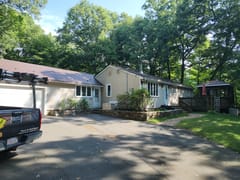Colonial Brown Interlock Shingle aluminum roof on a colonial style single-family home with a metal roof among, Burlington, Connecticut