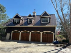 Colonial Brown Interlock Slate aluminum roof on a brown Colonial home with two-car garage in a wooded rural, Concord, New Hampshire