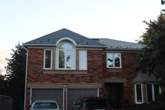 Two-storey brick Colonial home in Oakville with Interlock deep charcoal aluminum slate metal roof featuring multi-hip profile and snow guards.