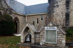 St. George's Anglican Church in Owen Sound, ON, with deep charcoal Interlock aluminum slate roofing on a steep multi-pitch stone heritage building.