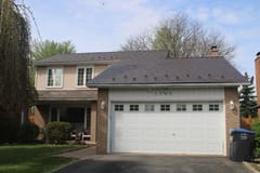 Two-storey Colonial-style home in Mississauga with Interlock aluminum cedar-shingle metal roofing in Colonial Brown, featuring snow guards and a brick chimney.