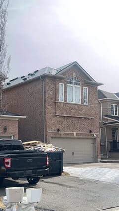 Deep Charcoal Interlock Slate aluminum roof on a brick two-storey home with dormers and a metal roof, Mississauga, Ontario
