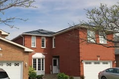 Black Interlock Standing Seam aluminum roof on a two-storey brick home with a black metal roof in a, Mississauga, Ontario