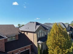 Tudor Brown Interlock Cedar Shingle aluminum roof on a brown two-storey home with dormers in a suburban setting, Oakville, Ontario