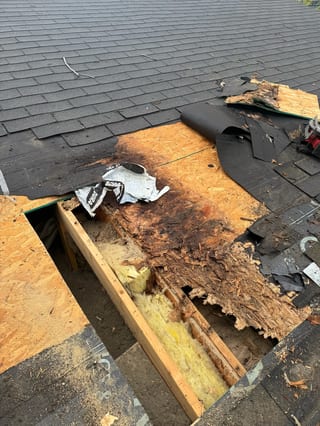 Black Interlock Shake aluminum roof being installed on a black home with dormers among tall pines, replacing a rotten asphalt shingle roof, Anchorage, Alaska