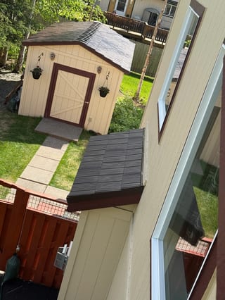 A metal roof in a craftsman style home in a forested setting