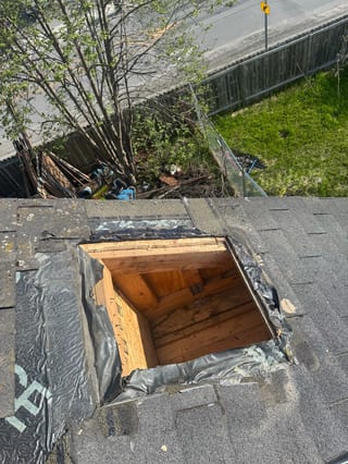 A metal roof under construction in a suburban area.