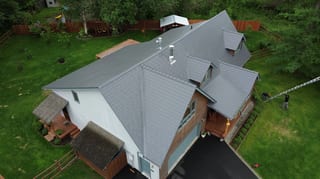 Metal roof in a modern style on a single-family home in a rural setting