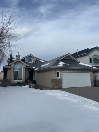 Weathered Interlock Slate aluminum roof on a beige one-storey home with a garage in a suburban, Calgary, Alberta