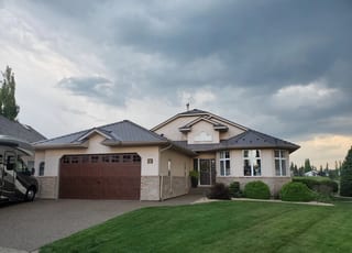 Weathered Interlock Slate aluminum roof on a tan ranch style home with a metal roof in a rural area, Red Deer, Alberta
