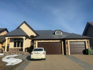 Charcoal Grey Interlock Slate aluminum roof on a beige bungalow with a metal roof in a rural suburban, Red Deer, Alberta